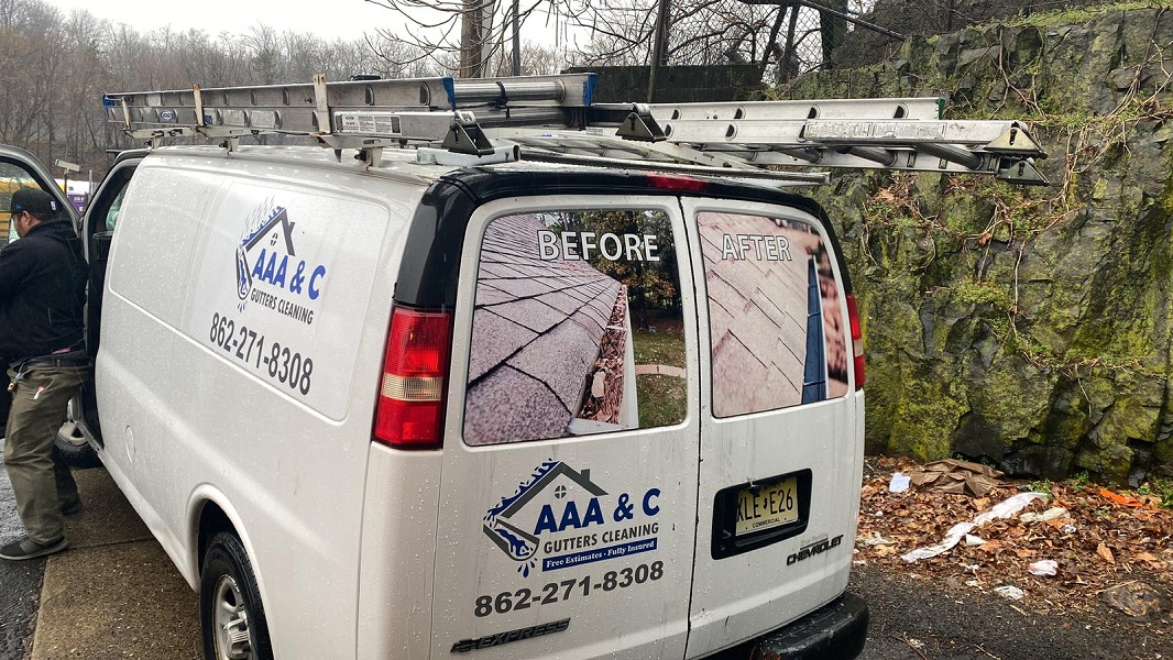 AAA & C Gutters Cleaning van with before-and-after photos on the rear windows